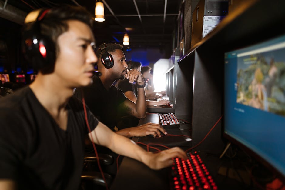 A diverse group of young adults playing esports inside a modern gaming cafe.