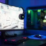 High-tech gaming setup featuring a curved monitor, RGB keyboard, and vibrant lighting. – AW2725DF custom resolution no