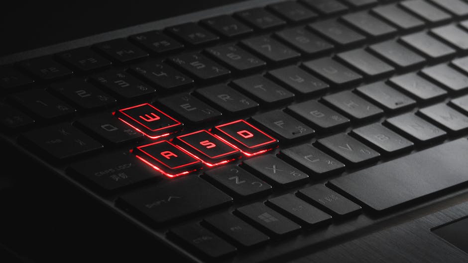 Close-up of illuminated WASD keys on a gaming keyboard with red LED lights.