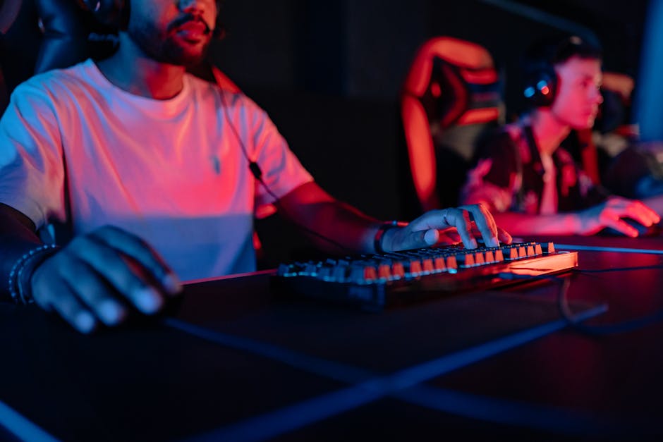 Two focused gamers in a neon-lit arena, wearing headphones and gaming intensely. – best gaming keyboards 2026