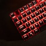 Close-up view of a red illuminated mechanical gaming keyboard in a dark room. – budget-friendly mechanical keyboard guide