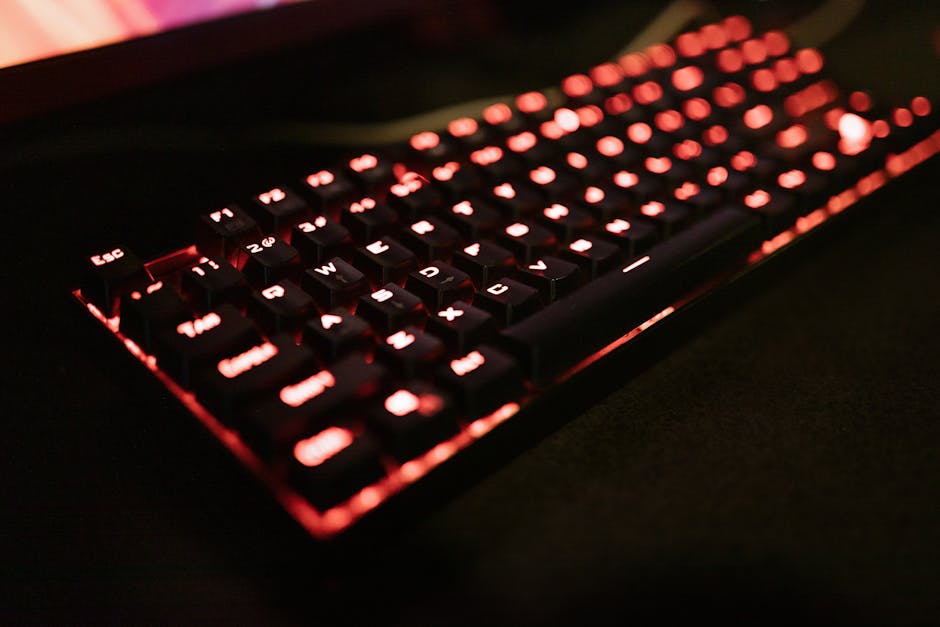 Close-up of an illuminated mechanical keyboard with red LED backlighting, perfect for gaming enthusiasts.