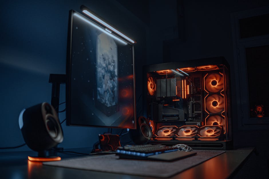 High-tech gaming computer setup featuring glowing LED fans and a dual monitor display.