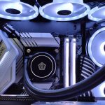 Detailed view of a computer setup with LED fans, motherboard, and graphics card in a gaming rig.