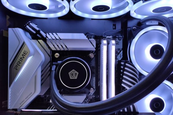 Detailed view of a computer setup with LED fans, motherboard, and graphics card in a gaming rig.