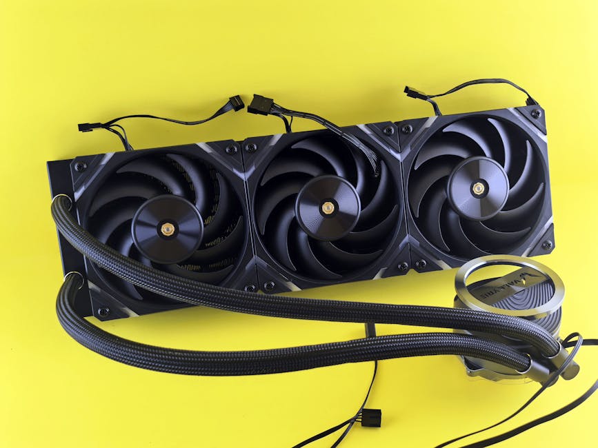 Three high-performance cooling fans with tubes displayed on a vibrant yellow background, highlighting advanced PC hardware.