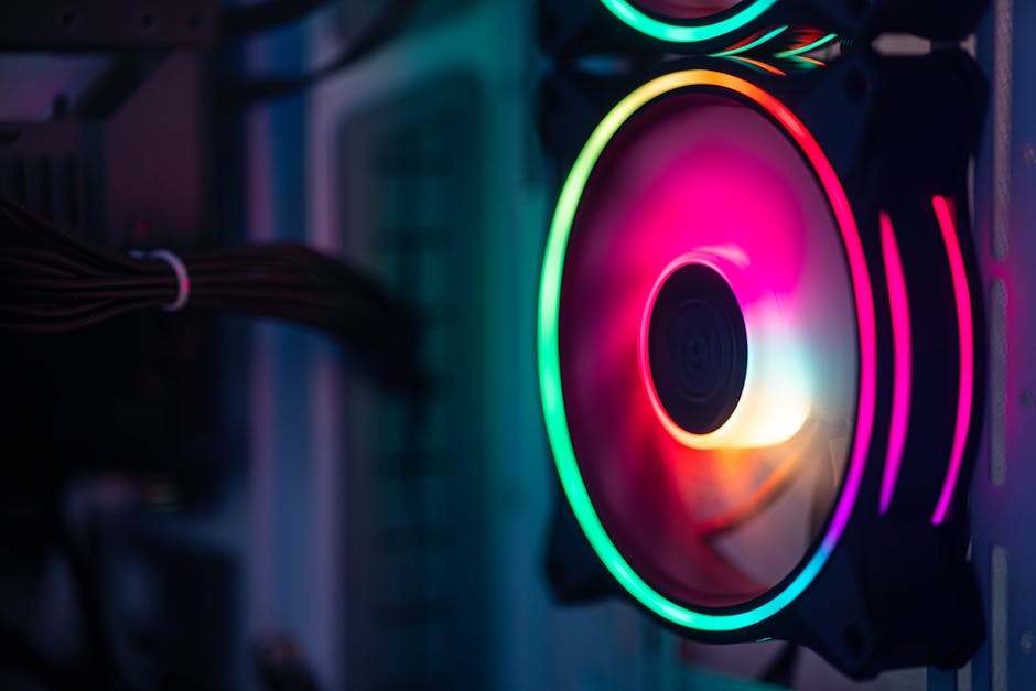 Close-up of a colorful RGB cooling fan in a gaming PC setup.