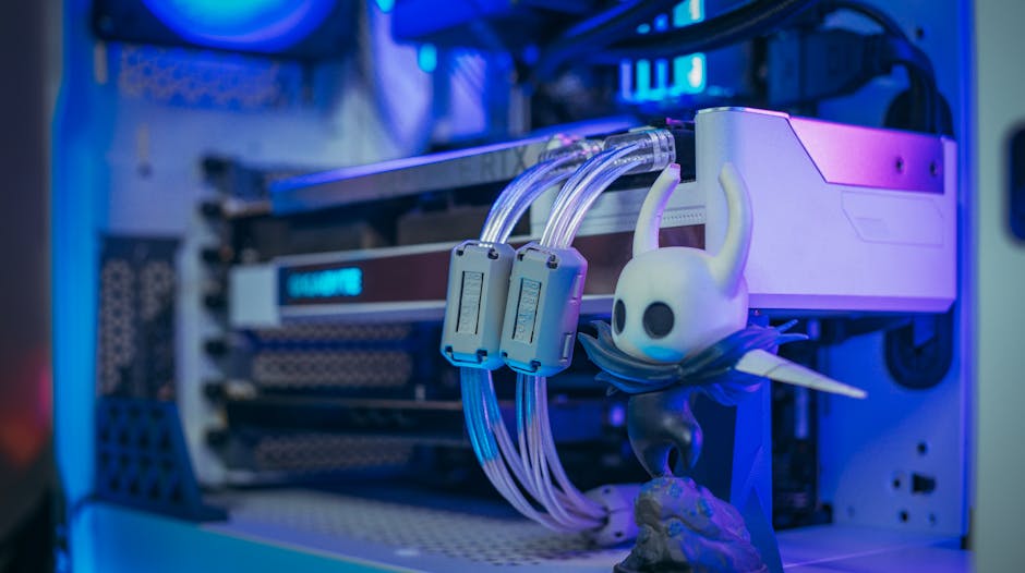 Close-up shot of a custom gaming PC with liquid cooling and figurine under blue lighting.
