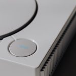 Detailed shot of a classic Sony PlayStation, highlighting the iconic open button and retro design. – console edition vs standard