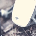 Detailed shot of a drone's body resting on outdoor ground, showcasing technology. – DJI Osmo Pocket 4 review