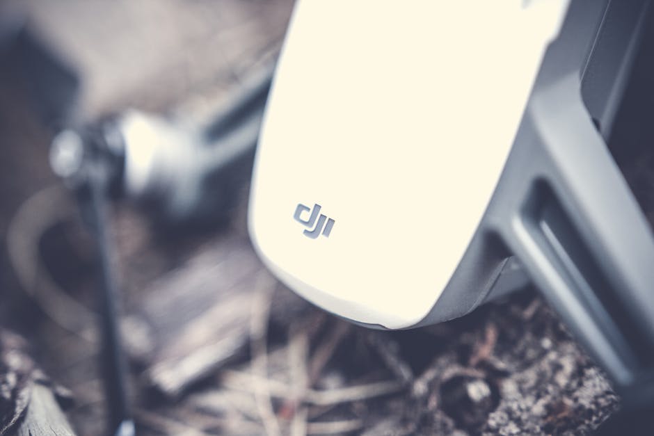 Detailed shot of a drone's body resting on outdoor ground, showcasing technology. – DJI Osmo Pocket 4 review
