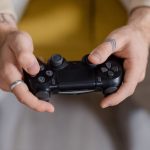 A gamer holding a black game controller, focusing on gaming and entertainment. – best gaming hardware