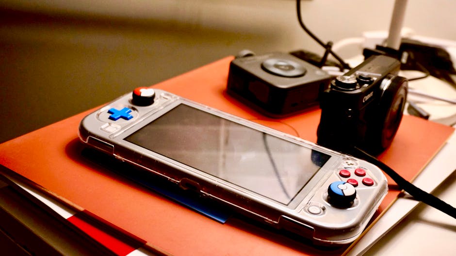 A portable gaming console beside a digital camera showcases modern entertainment and technology setup. – gaming collections worth the