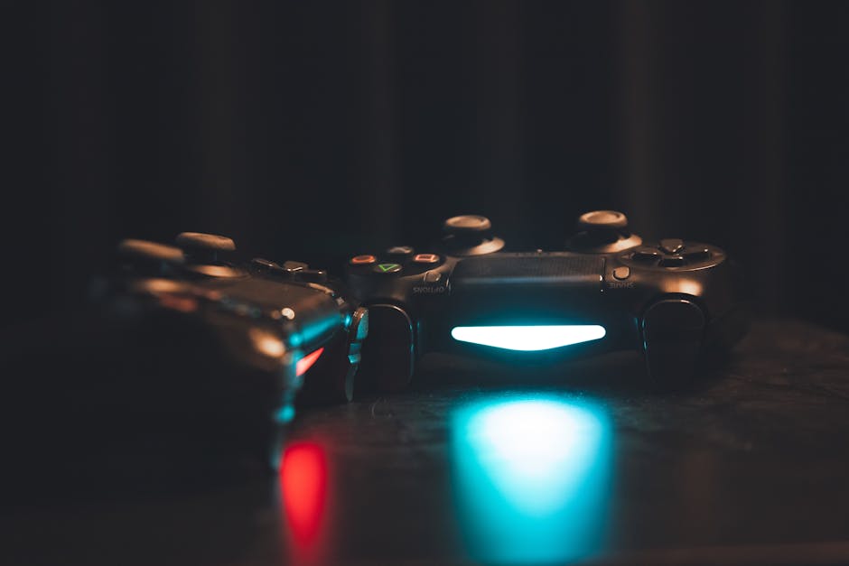 Close-up of glowing gaming controllers on a dark surface, creating a moody ambiance. – gaming hardware explosion concerns