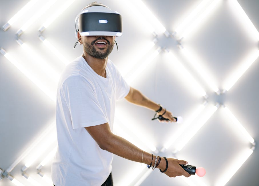A young man immersed in a virtual reality gaming session with controllers, smiling and interactive.