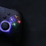 Close-up of a glowing gaming controller against a dark background, highlighting technology and entertainment. – IPS glow vs backlight