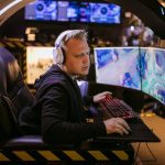 A focused gamer using an advanced multi-monitor setup in a modern gaming chair. – Mad Catz MMO7+ Gaming Mouse