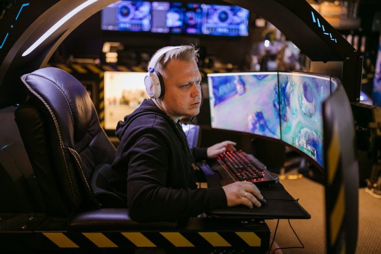A focused gamer using an advanced multi-monitor setup in a modern gaming chair. – Mad Catz MMO7+ Gaming Mouse