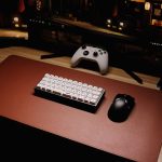 High-angle view of a sleek gaming setup featuring a mechanical keyboard and controller. – mechanical keyboard for beginners