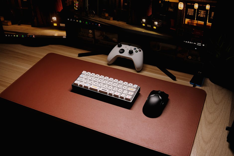High-angle view of a sleek gaming setup featuring a mechanical keyboard and controller. – mechanical keyboard for beginners