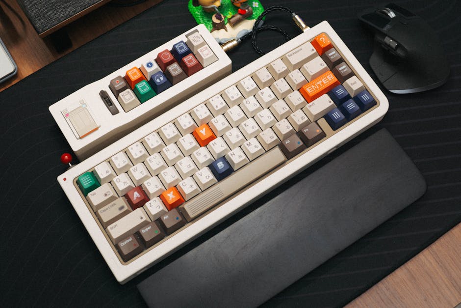 A vintage-style mechanical keyboard with colorful keycaps and side keypad on a desk setup.