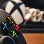 Detailed view of Xbox gaming controller with vibrant buttons displayed indoors. – Microsoft Windows server reboot