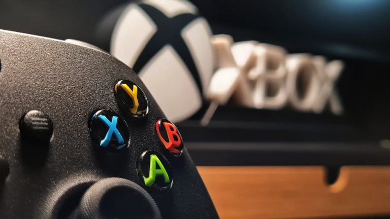 Detailed view of Xbox gaming controller with vibrant buttons displayed indoors. – Microsoft Windows server reboot