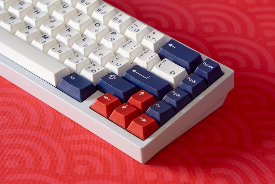Close-up of a white and red mechanical keyboard with blue keys on a vibrant red surface.
