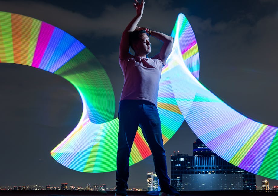 A dynamic scene of a woman posing with multicolored light trails on an urban rooftop at night.
