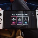 Close-up of a person holding a gaming console with an on-screen decision prompt.