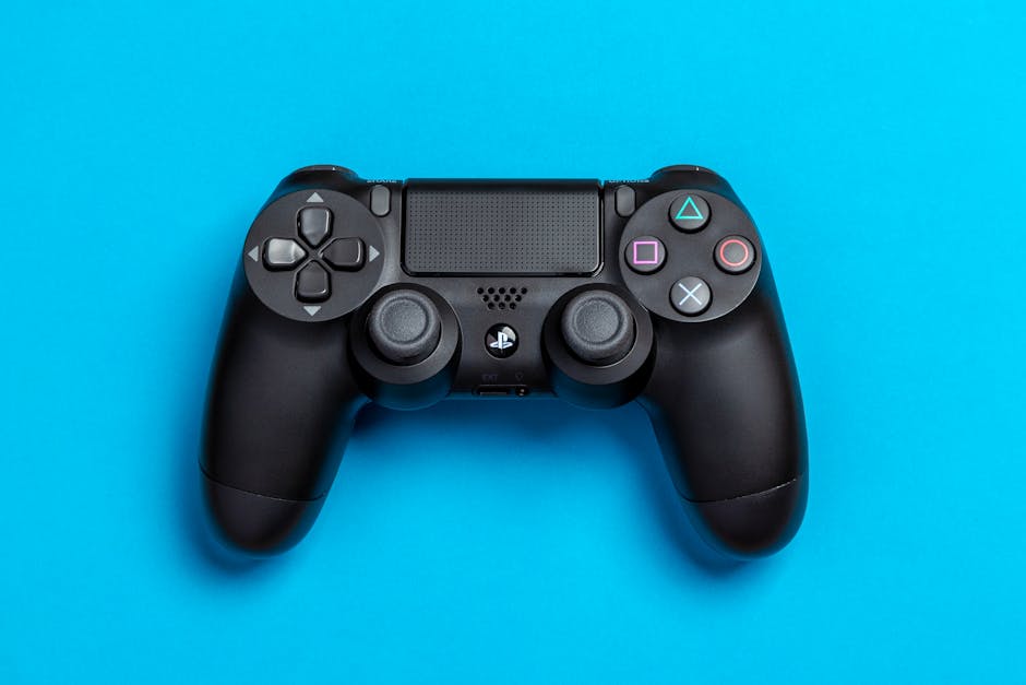 Black game controller against a vibrant blue background, perfect for gaming-themed content.
