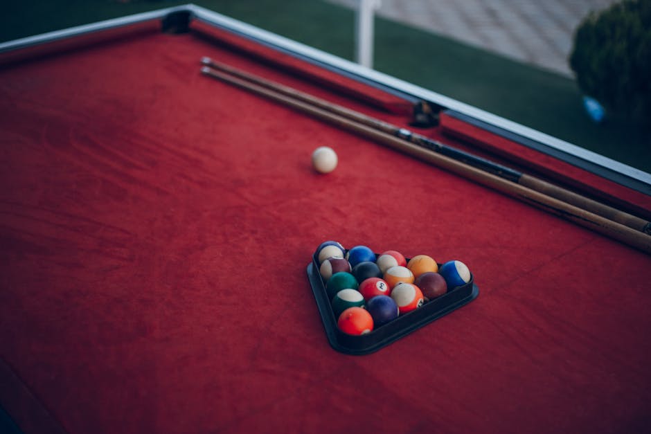 Close-up of a billiard table with colorful balls set for a game, perfect for sports enthusiasts.