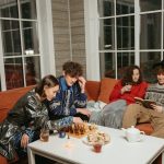 A group of friends enjoying a cozy indoor evening, sipping drinks and playing chess together. – Steam Cozy RPG Disappearance Tetris Controversy