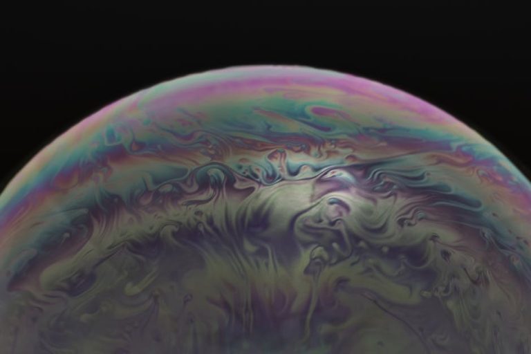Vibrant macro image capturing the swirling colors and patterns of a soap bubble. – AI bubble in the tech industry