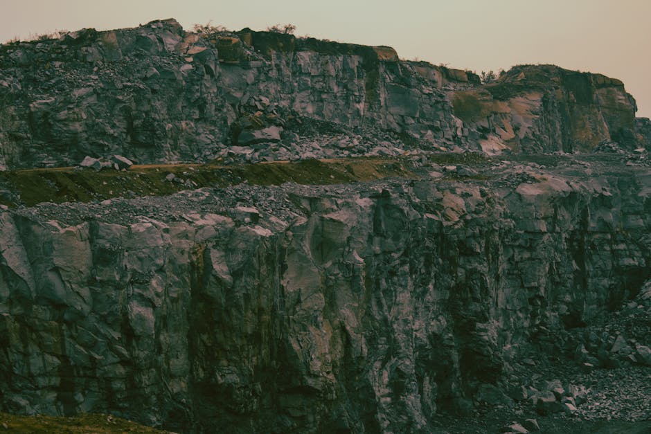Stunning image of steep, eroded rock formations in a quarry at dusk.
