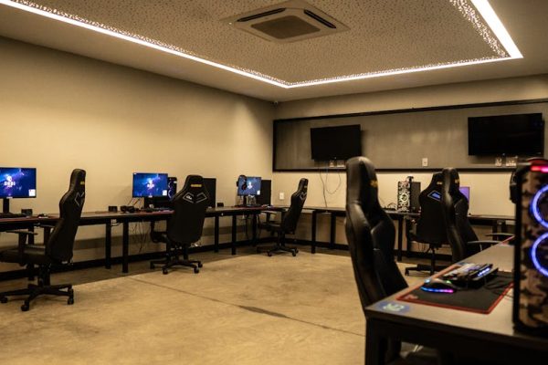A modern gaming room featuring high-performance PCs, gaming chairs, and sleek design. – trepang2 price drop pc