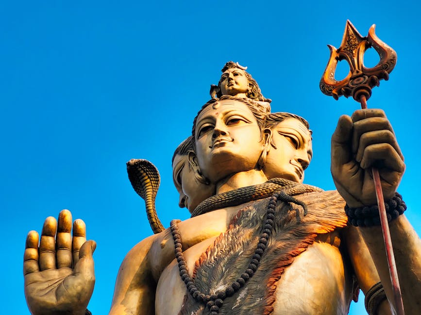 Stunning close-up of Lord Shiva statue with a clear blue sky in Howrah, India.