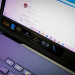 Close-up of an open laptop focusing on screen and keyboard with various icons and text. – 1440p QD-OLED text fringing